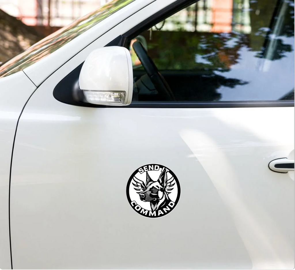 Durable SEND IT COMMAND logo sticker on a white vehicle door, showcasing bold design and strong presence.