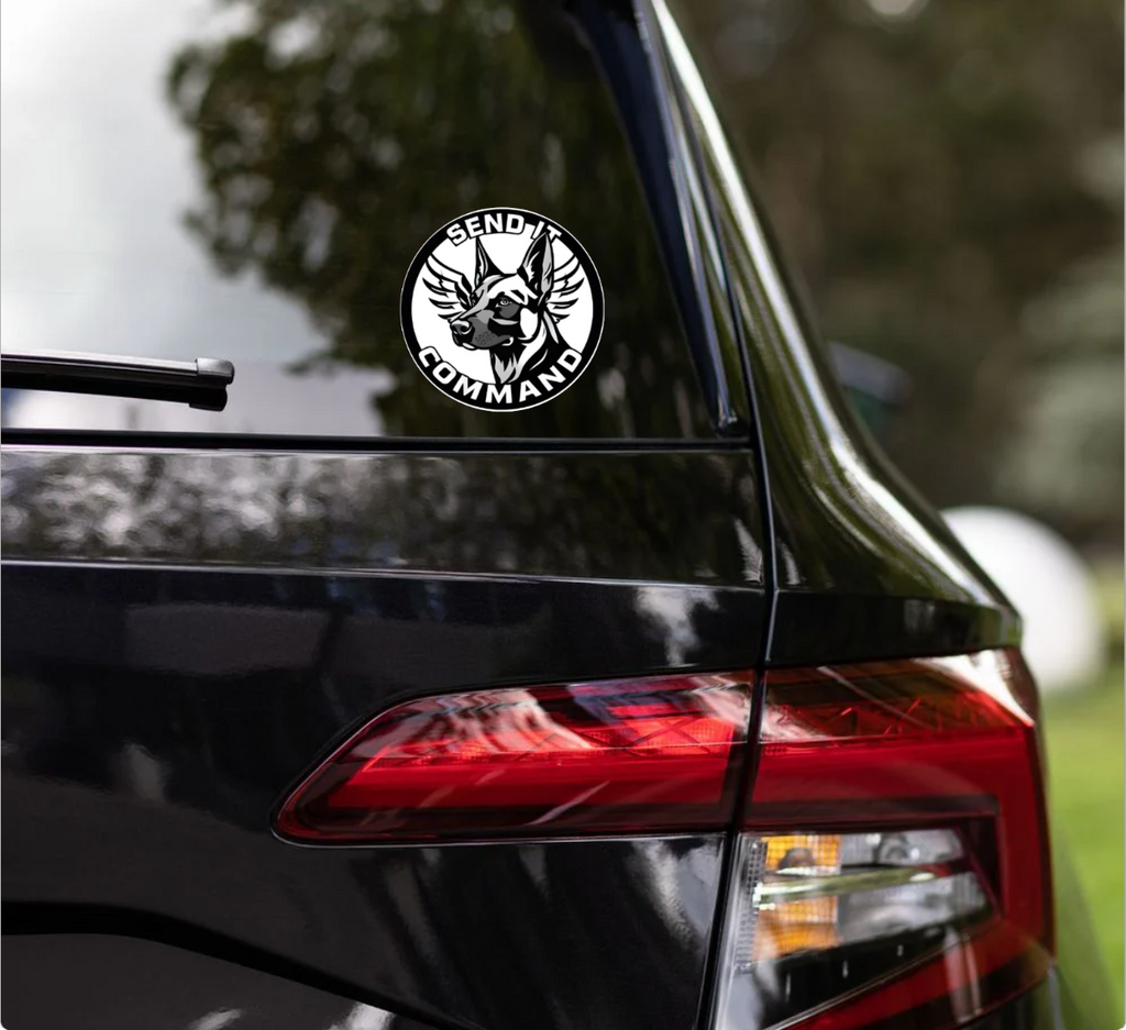 Durable SEND IT COMMAND logo sticker displayed on a black vehicle's rear window.